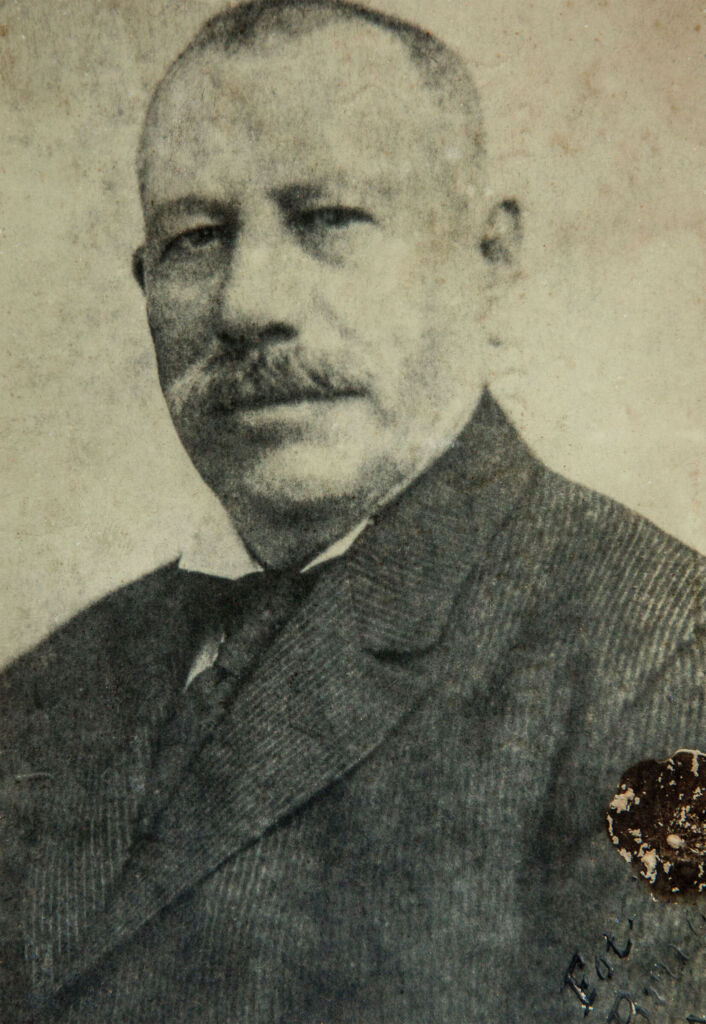 A black and white photograph of the Rum production company founder