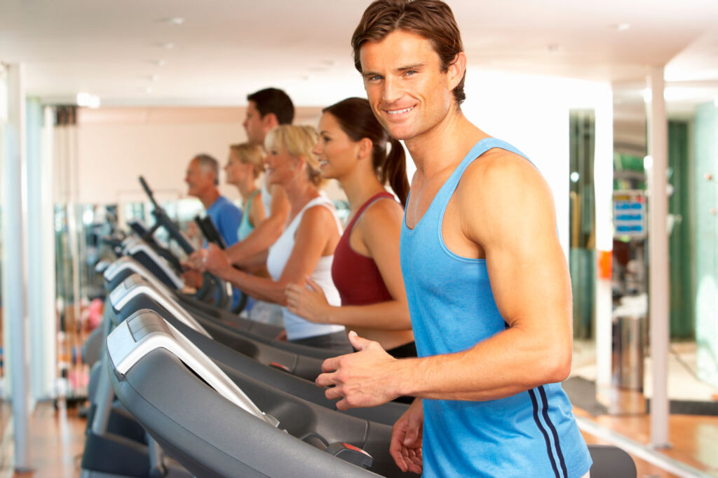 A man exercising on a treadmill in a gym