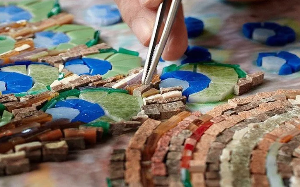 A craftsman placing tiles into a pattern