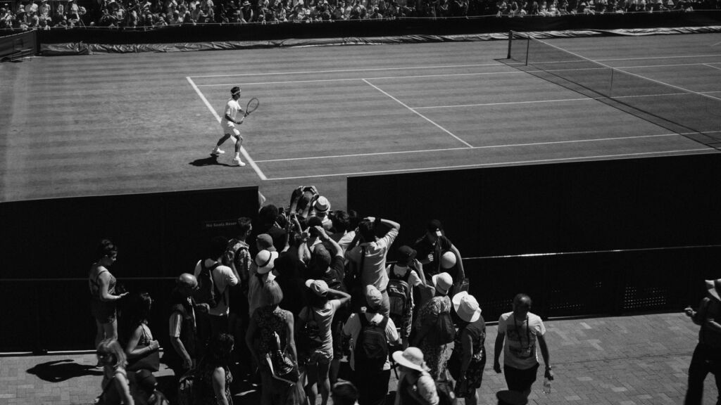 A black and white photo of a historic men's tennis match