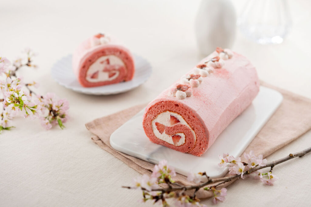 A Sakura roll cake cut in half showing its contents