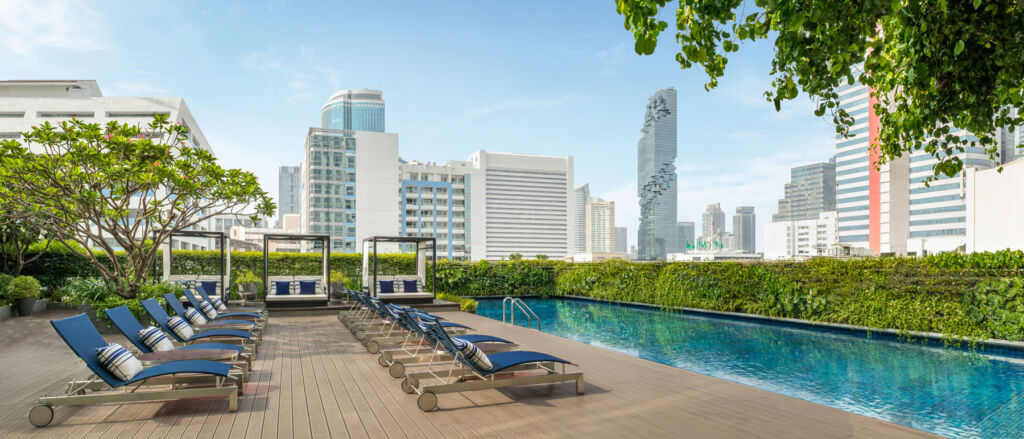 The pool with its recliners and views of the Bangkok skyline
