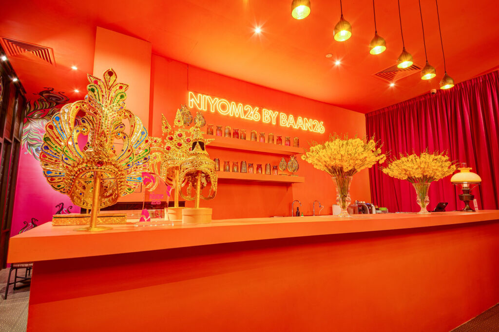 The Peacock Bar, painted bright orange with traditional gold coloured Thai ornaments