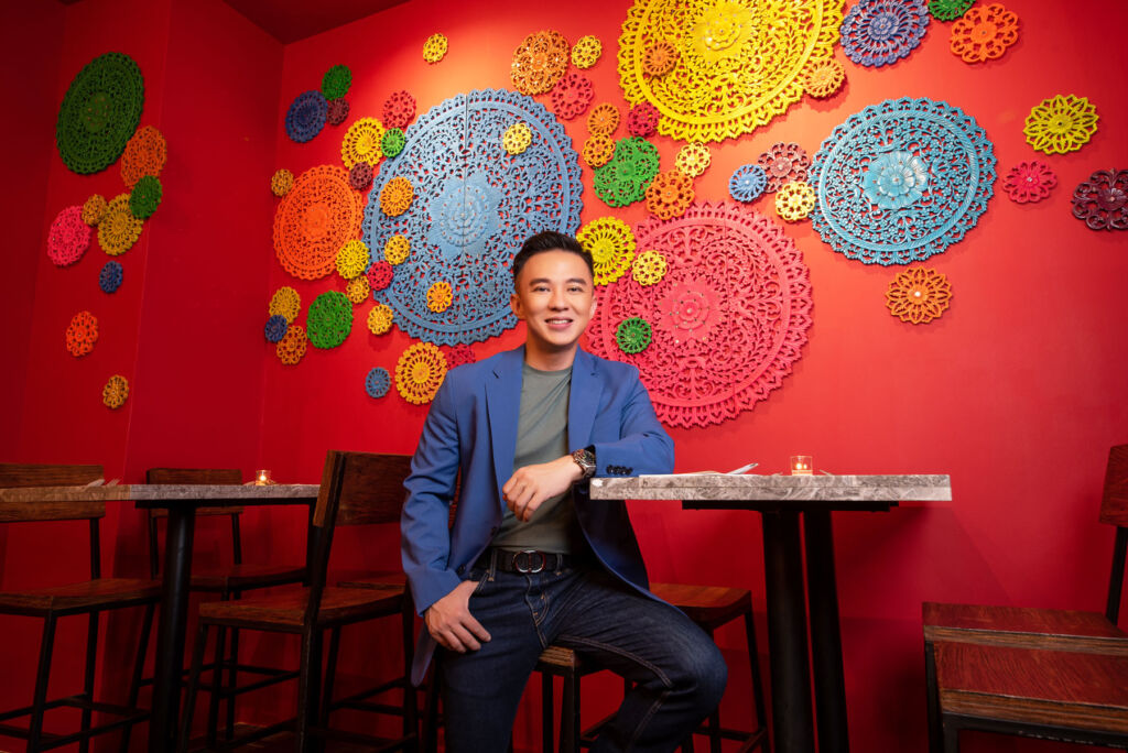 The restaurant founder, Chai, sat at one of the dining tables