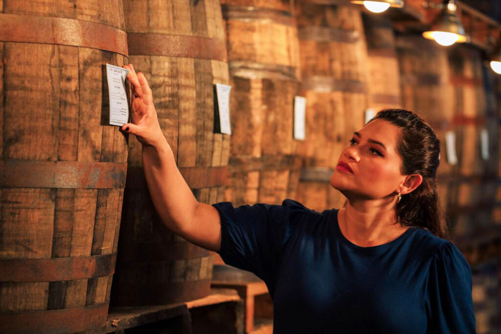 The world's youngest female Rum Master inspecting the casks