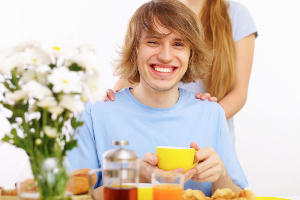 A young man enjoying a freshly made cup of tea