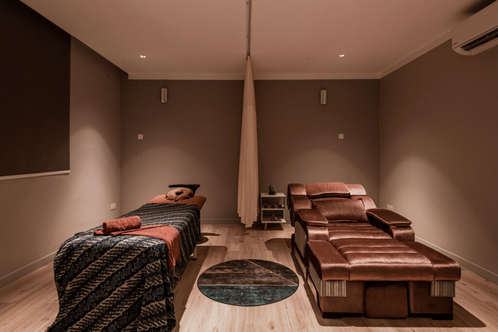 The spa treatment room with its massage table and massage chair