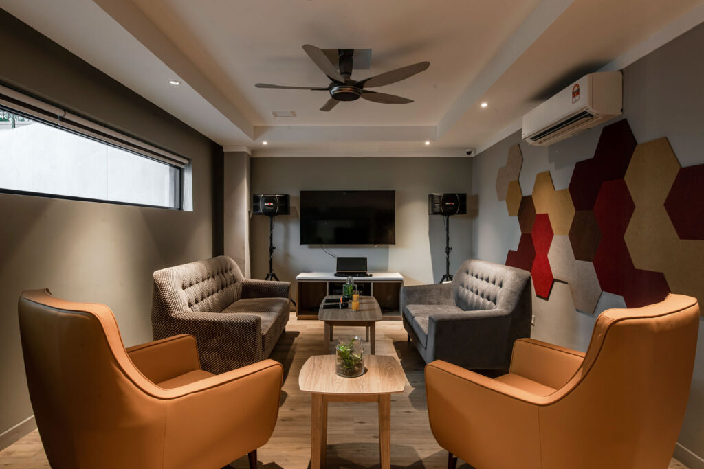One of the communal living areas with a large TV and sound system and plush seating