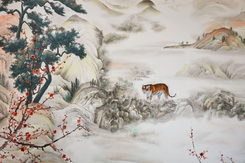 A Tiger in the mountains on hand-embroidered wallpaper 