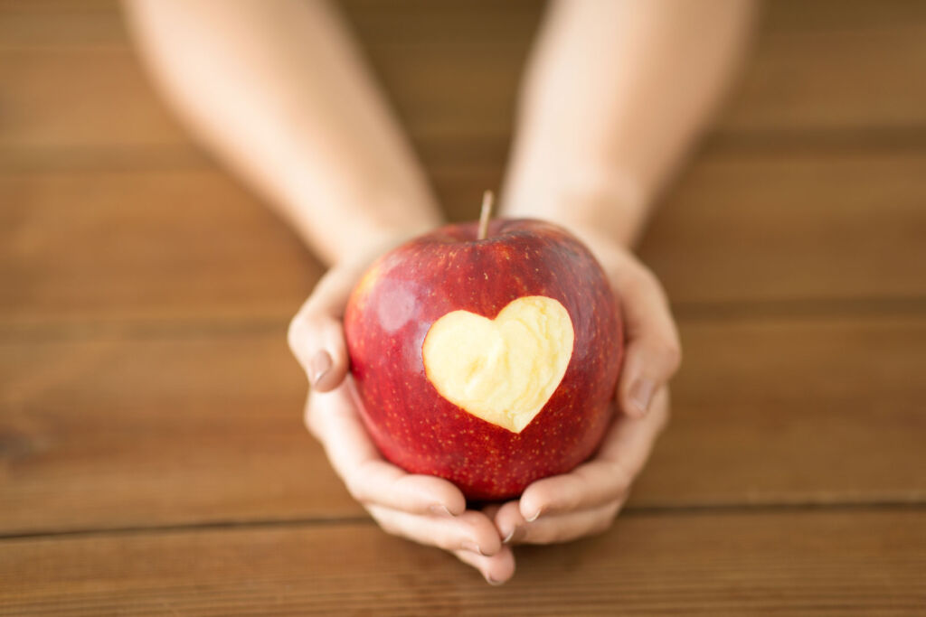 A red apple with a heart in its skin