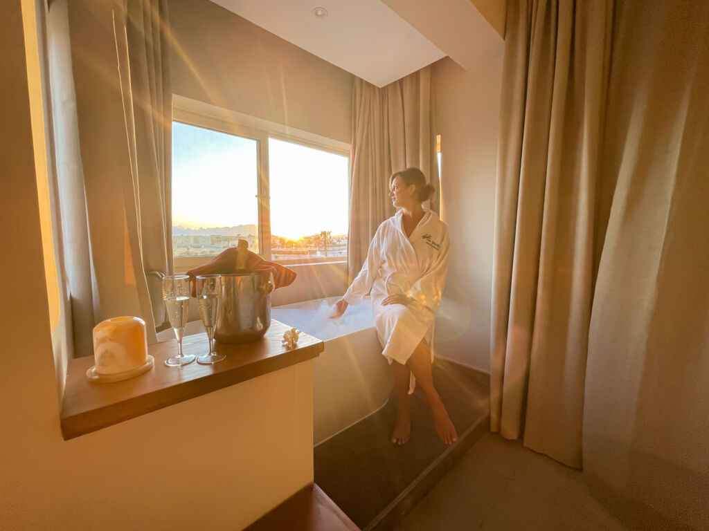 A female guest admiring the view from her suite