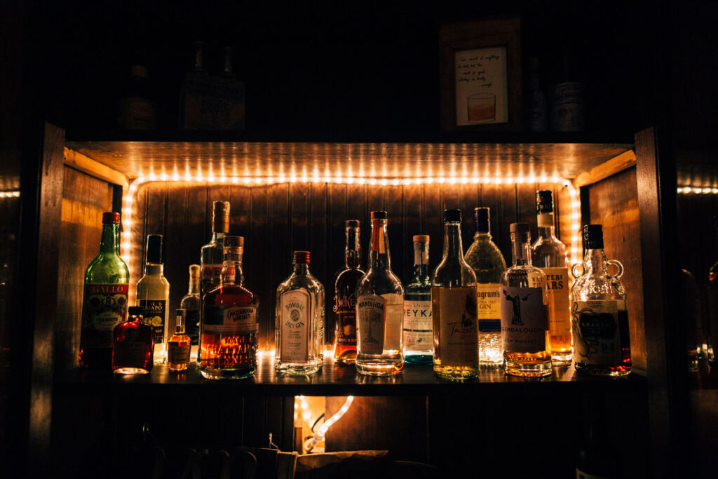 A rare collection of whiskies in a cabinet