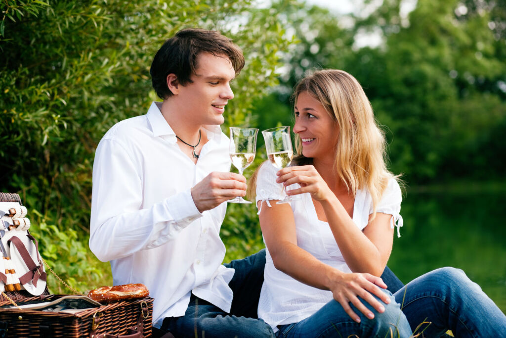 A couple enjoying some English Wine by a Canal