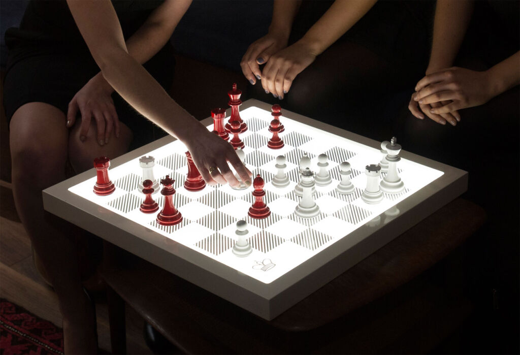 People playing a game on an illuminated board