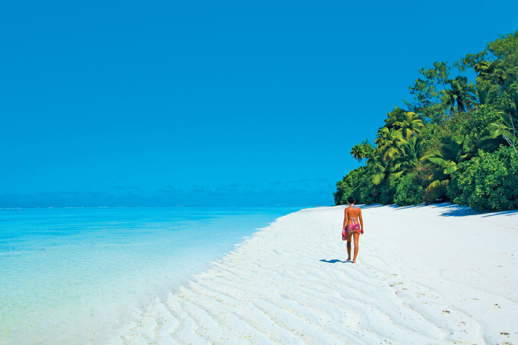 A woman enjoying walking along a beautiful deserted beach