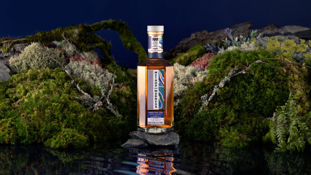 A bottle of the METHOD and MADNESS Garryana Oak edition in a natural setting