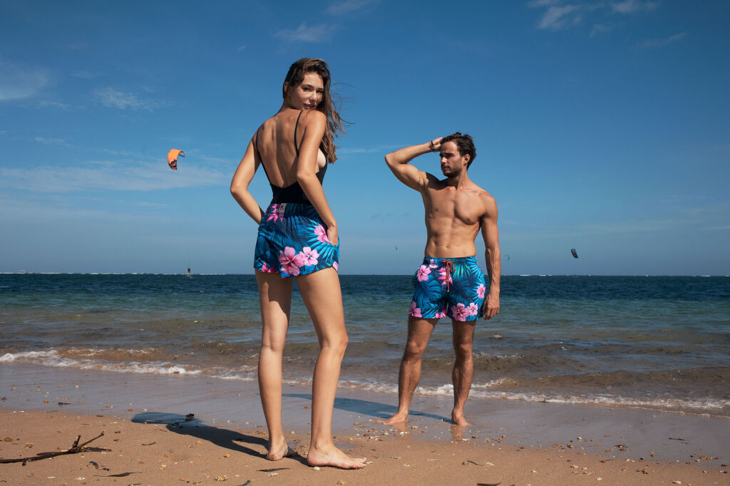 Two models wearing the resortwear on the beach
