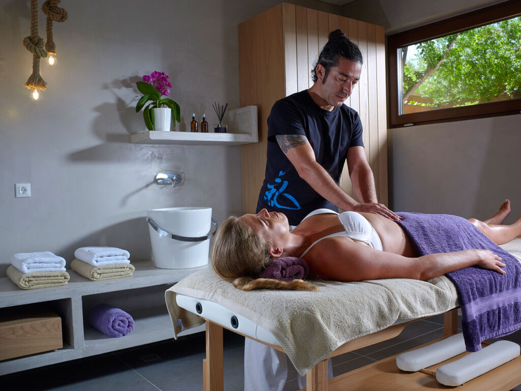 Sabi Phagura getting a firm massage from Michalis