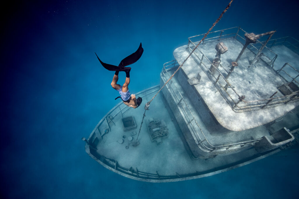 A free diver heading down to imspect a shipwreck