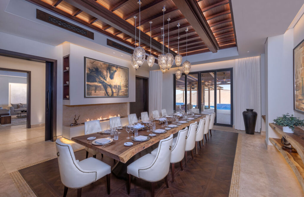 Inside the spacious indoor dining area with its long wooden table and white leather chairs