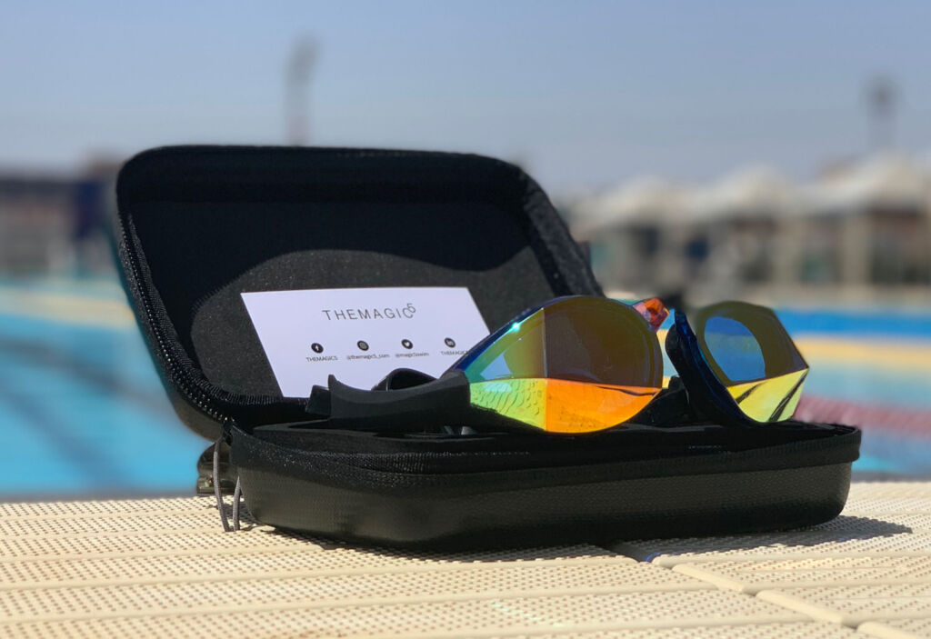 The goggle in its case by the side of a swimming pool