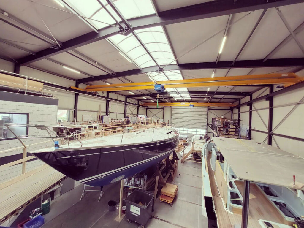 A sailing yacht being constructed inside the boatbuilders premises
