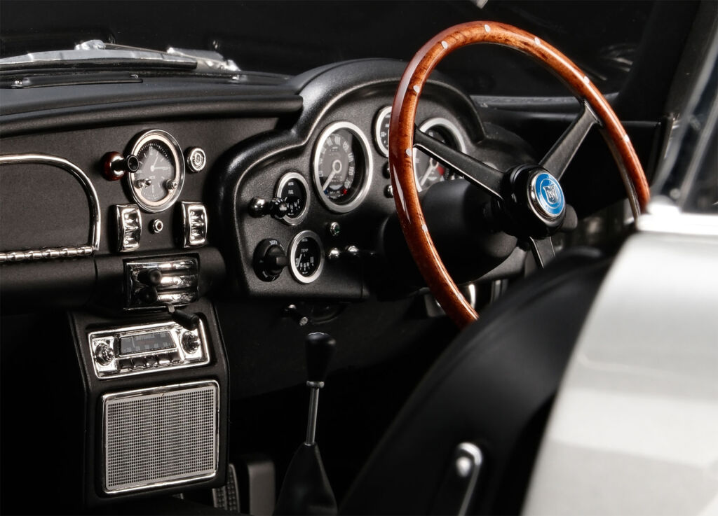 A close up view of the dashboard and wooden steering wheel