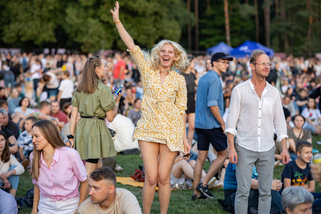 An excited blonde haired lady at the festival