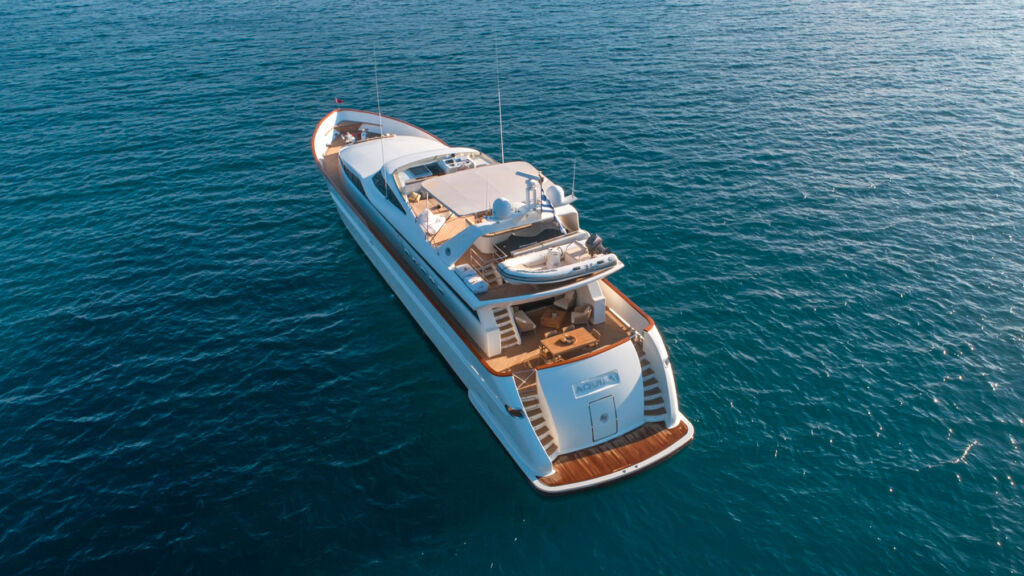 An aerial view of the Aquila Yacht on a calm sea