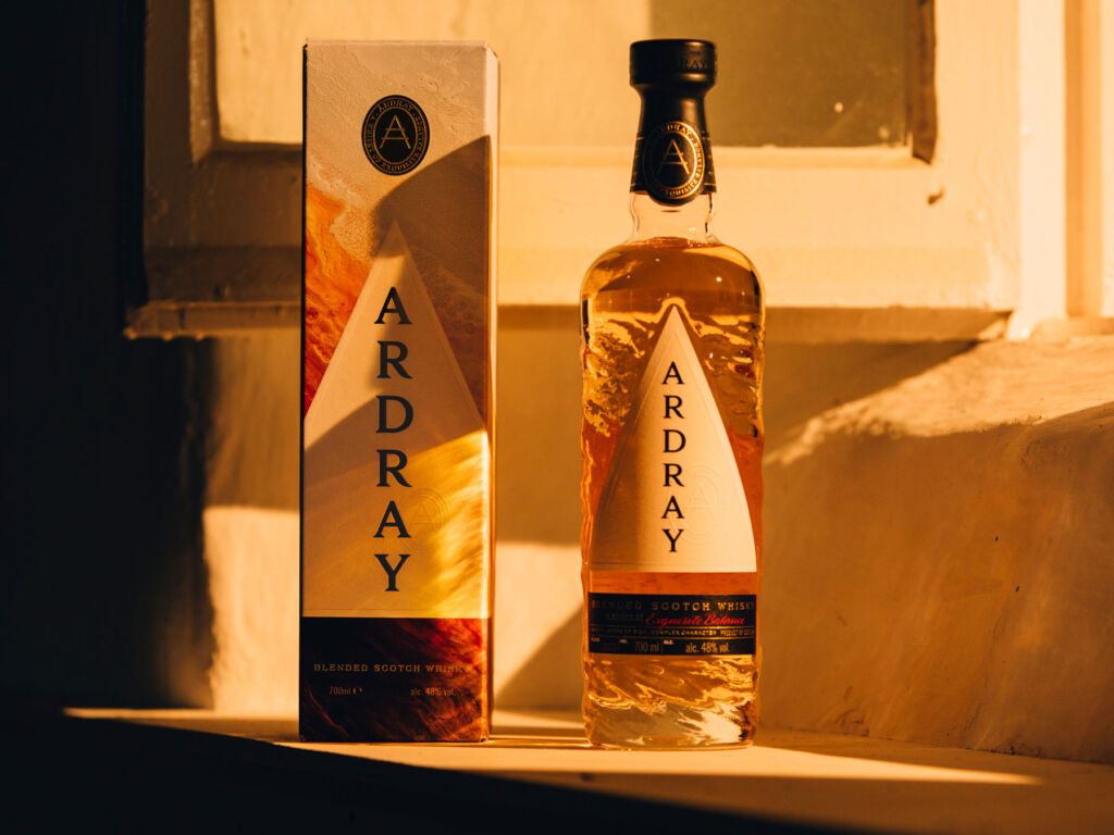 A bottle of Ardray on a window sill next to its box