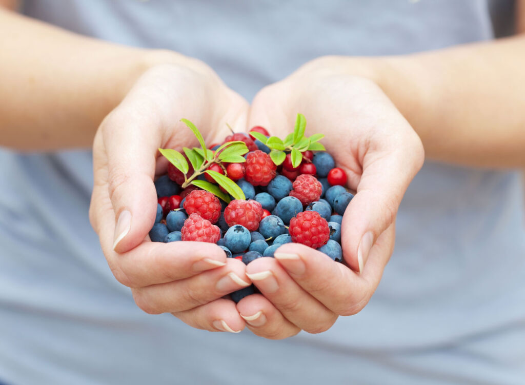 A woman holding some berries in her hands