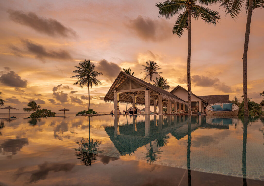 A view over the resort's pool at sunset
