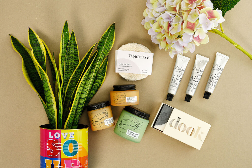 Some of the ethically sourced products next to plants and flowers