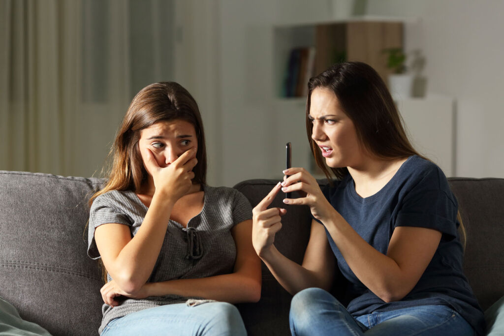 Two young women arguing over social media