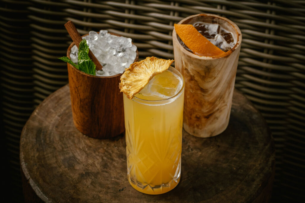 Three wood element cocktails on a table