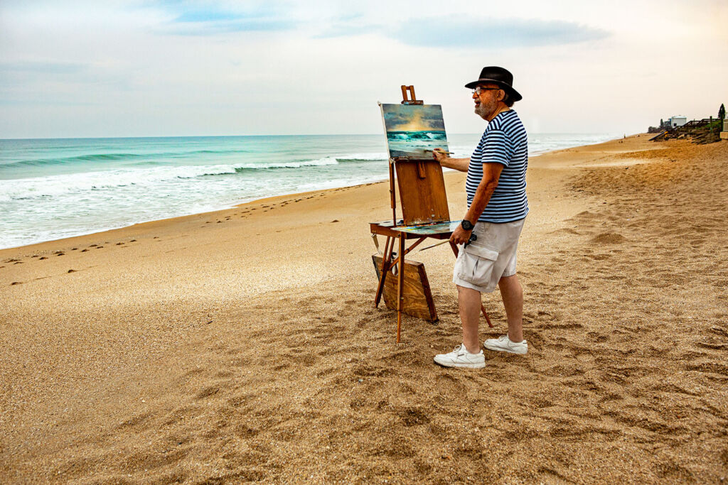 Frank painting on the beach