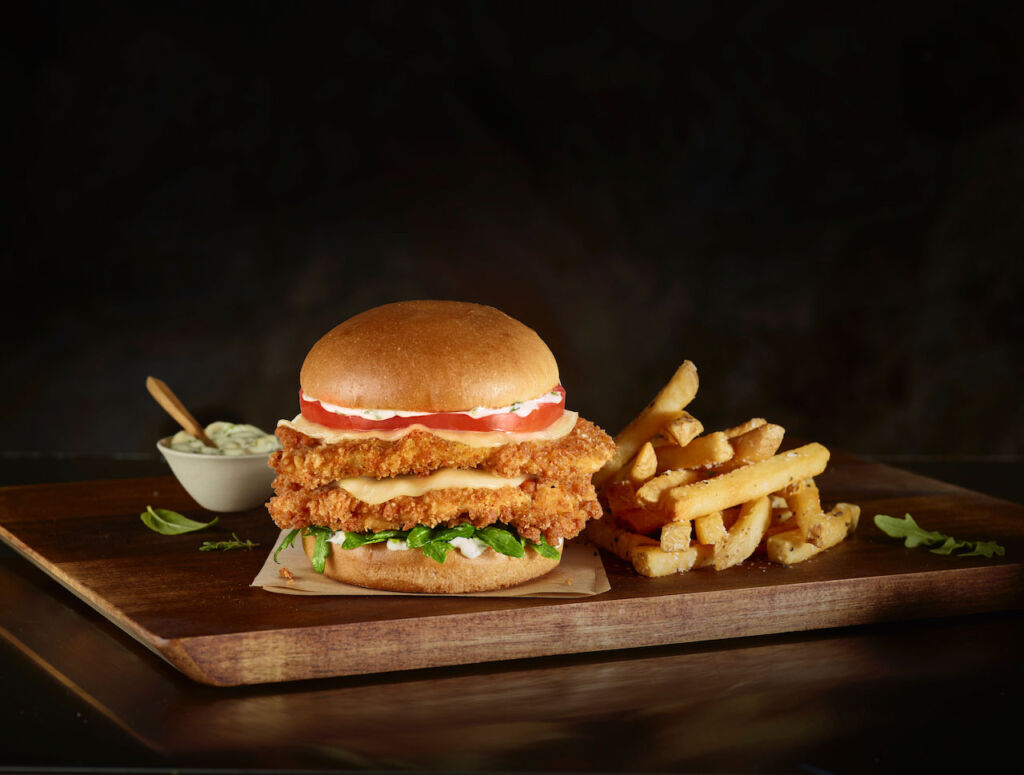 A photograph of the chicken sandwich with some fries