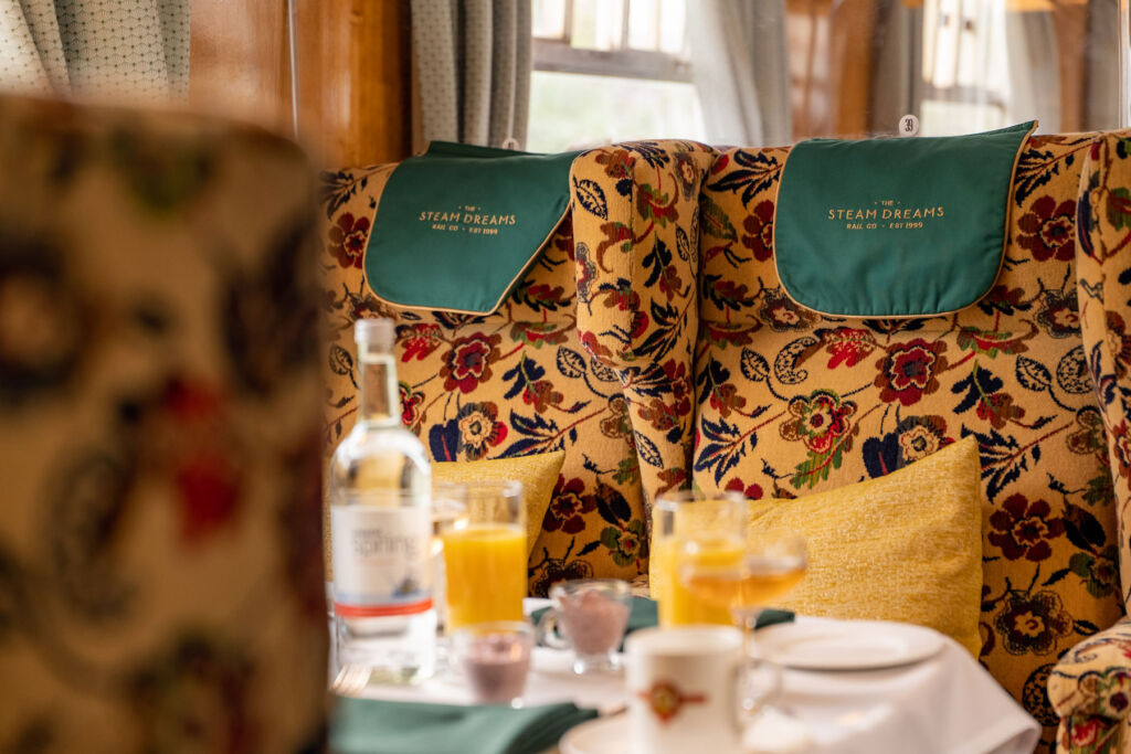 The bright coloured patterned seating inside the carriage
