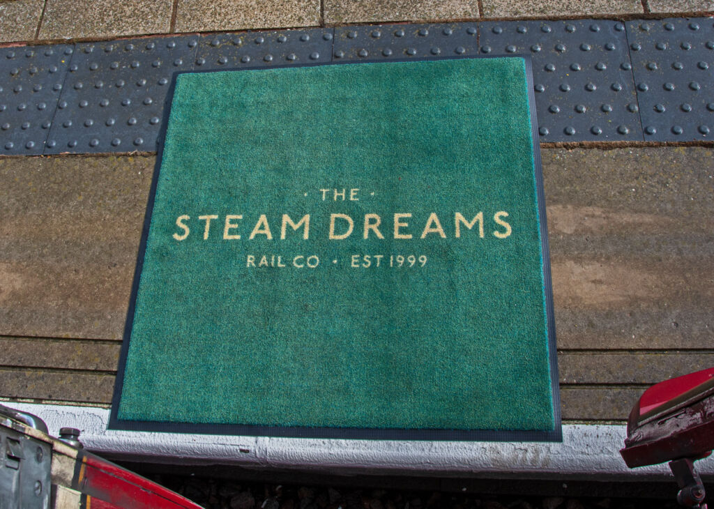 The Steam Dreams embroidered mats for guests boarding and leaving the carriages
