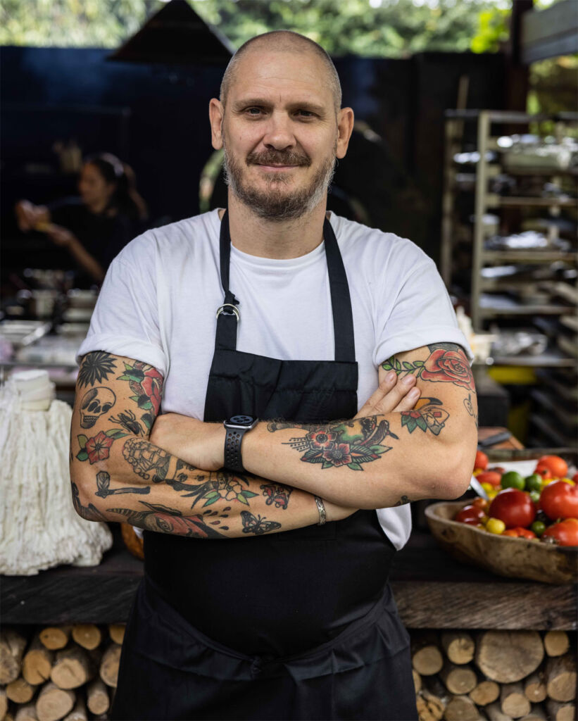 Chef Stephen standing with his arms folded outdoors