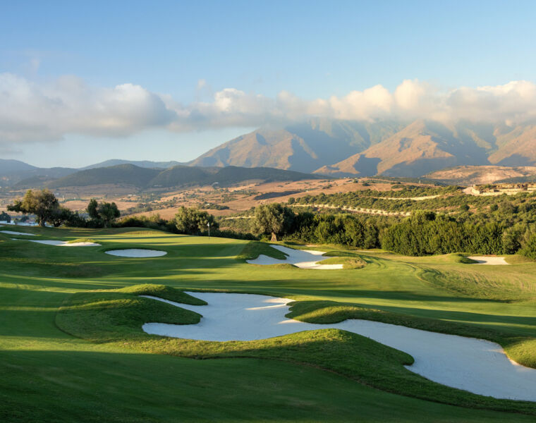 A panoramic view of the golf course with the mountains in the background