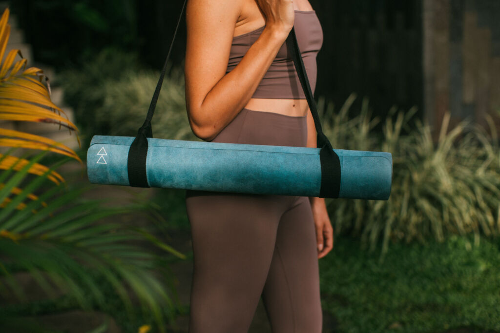 A yoga mat being carried on the shoulder