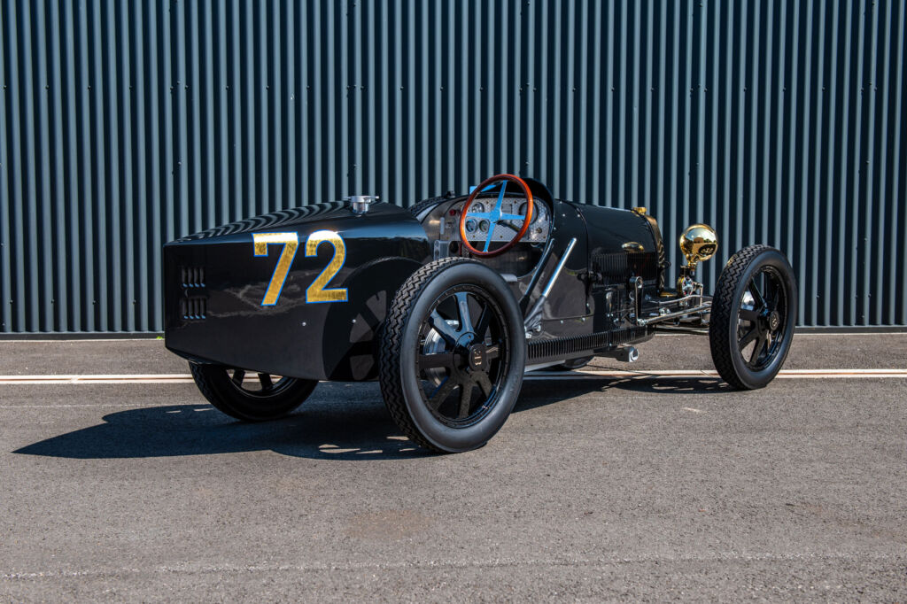 A rear three quarter views of the car with the number 72 on the rear in a gold colour