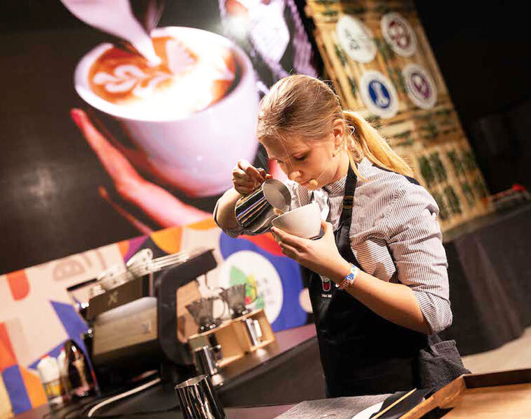 A young female Barista making a coffee