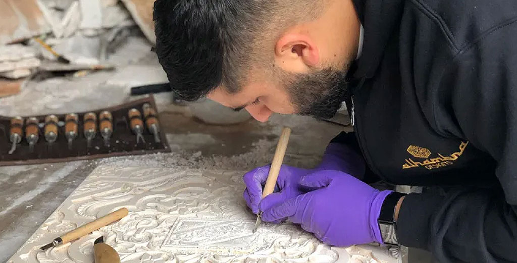 Ahmed etching Islamic patterns into a new piece