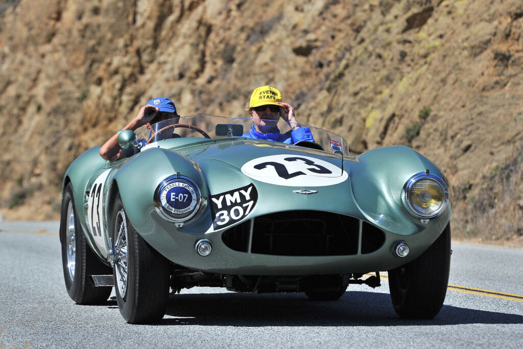 A man and woman enjoying driving the DB3S on a sunny day