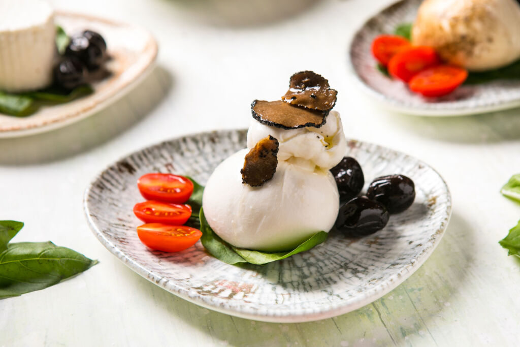 The Burrata dish with black olives, tomato and truffle