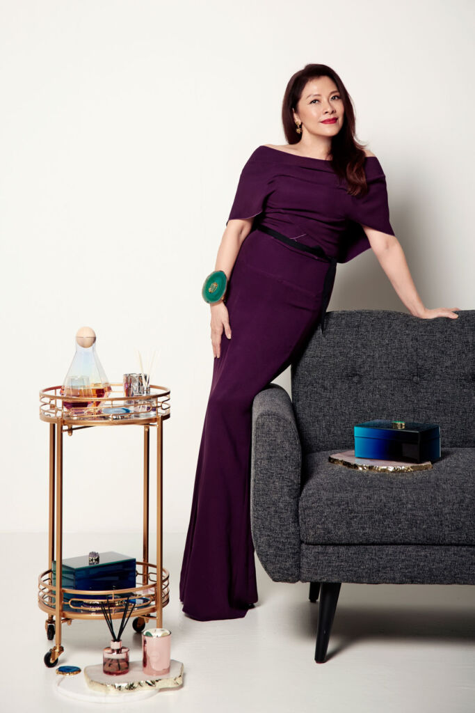Catherine wearing a long purple dress in her home