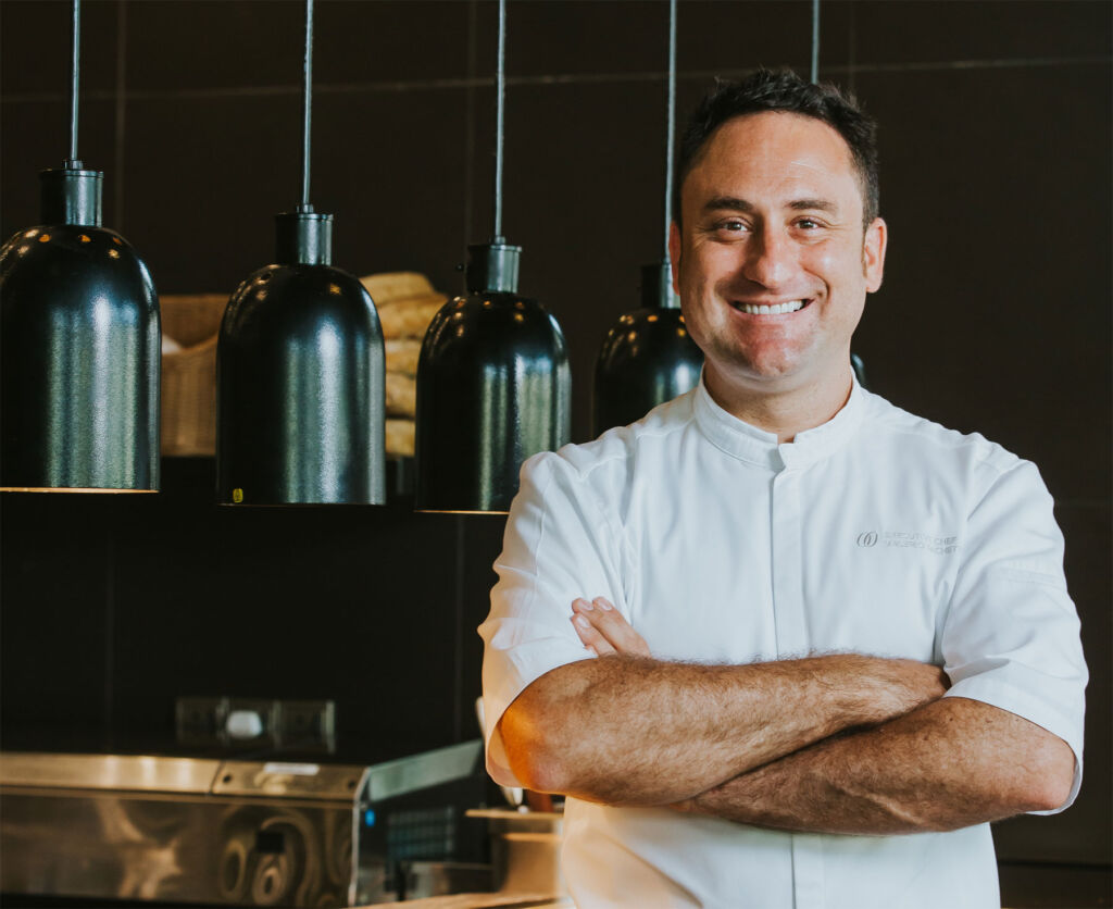 A happy Chef Valerio Pachetti in his kitchen