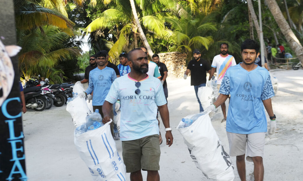 Staff collecting plastic bottles from around the resort